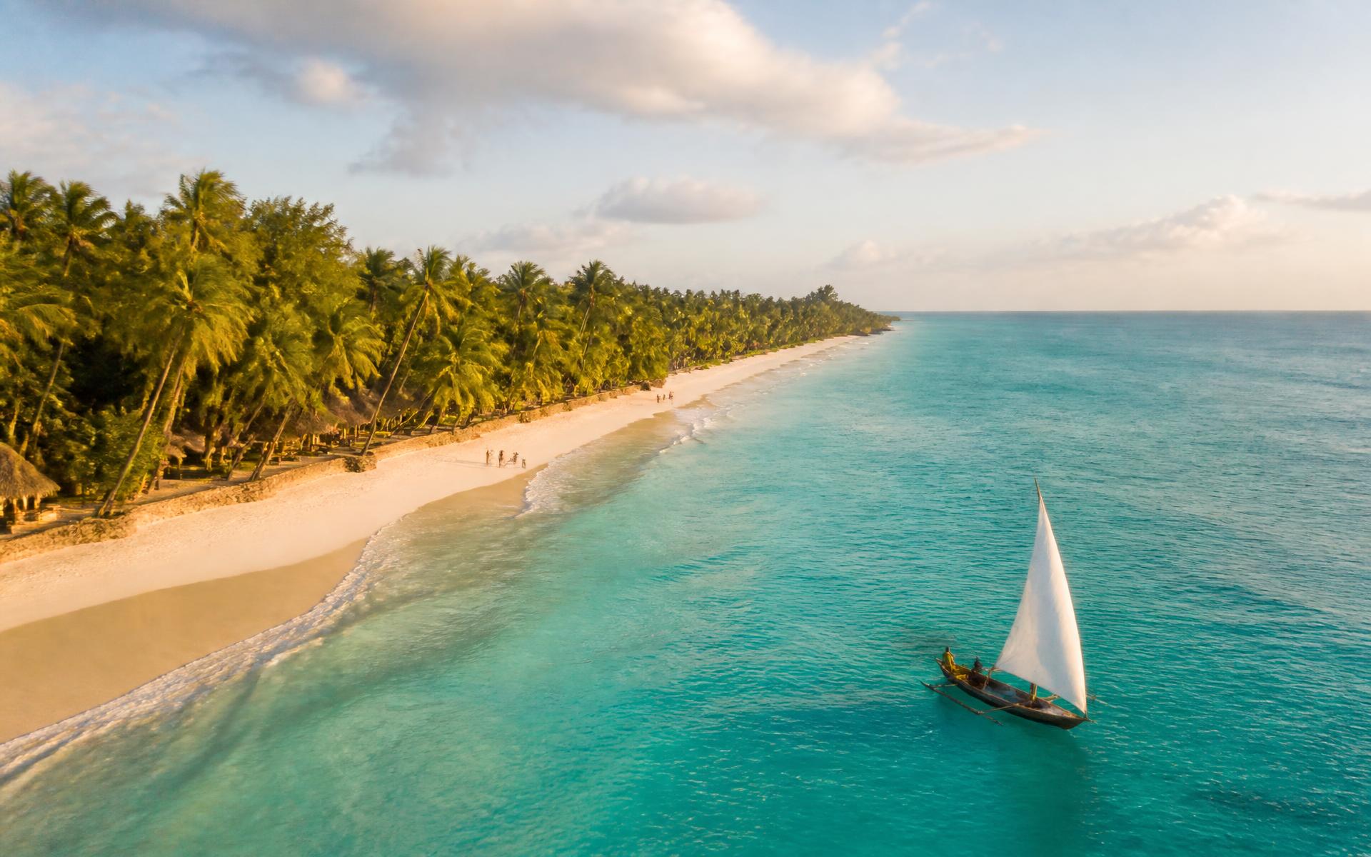 Aerial view of Diani Beach with a dhow sailing on turquoise water
